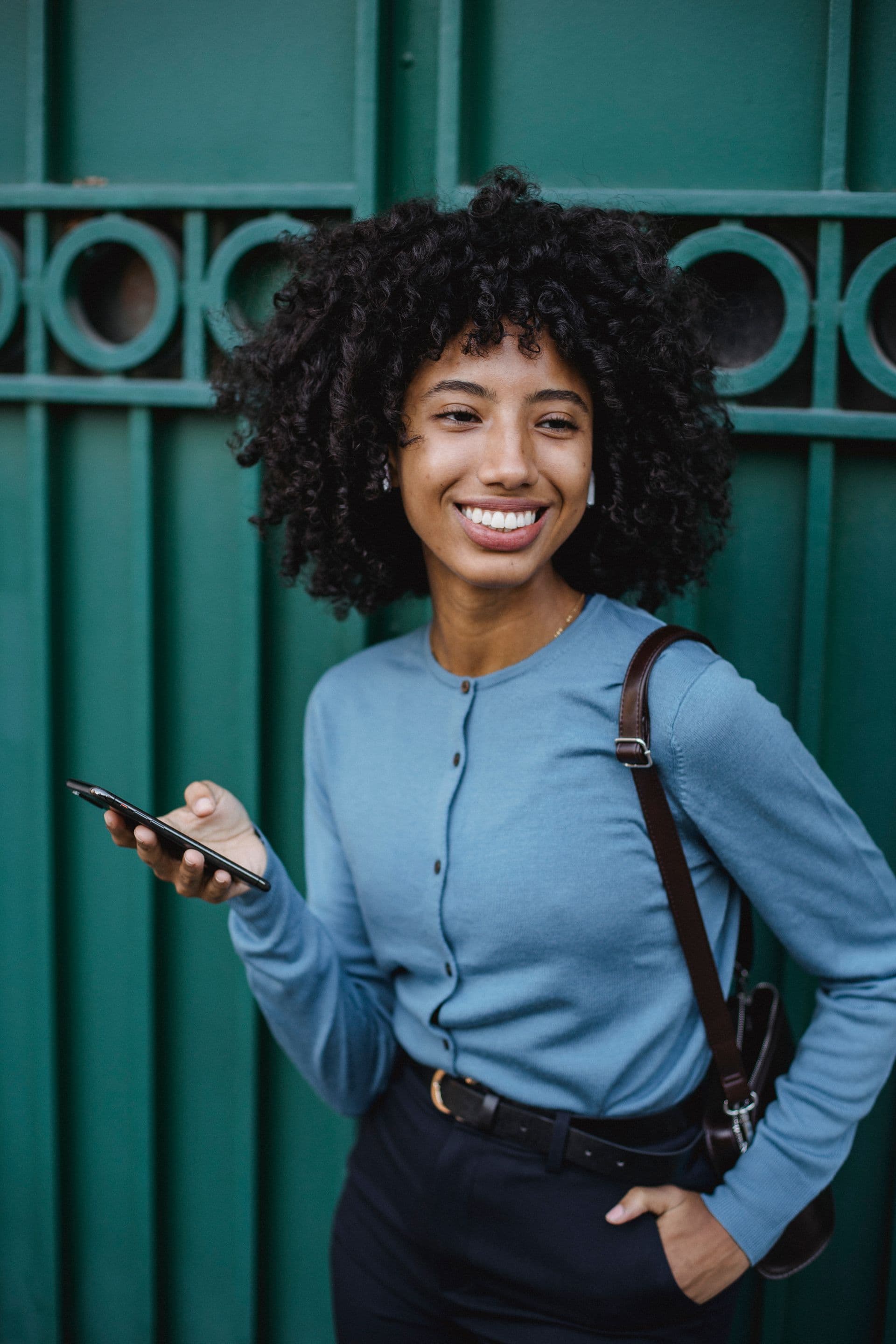 Woman smiling while using her phone